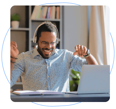 Happy man on laptop listening to music