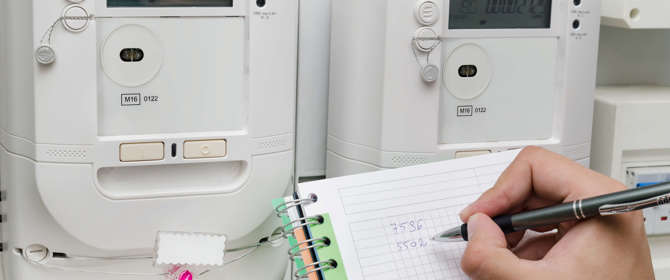 Person Reading Gas And Electricity Meters