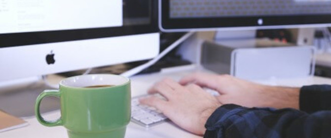 Person Typing At Computer
